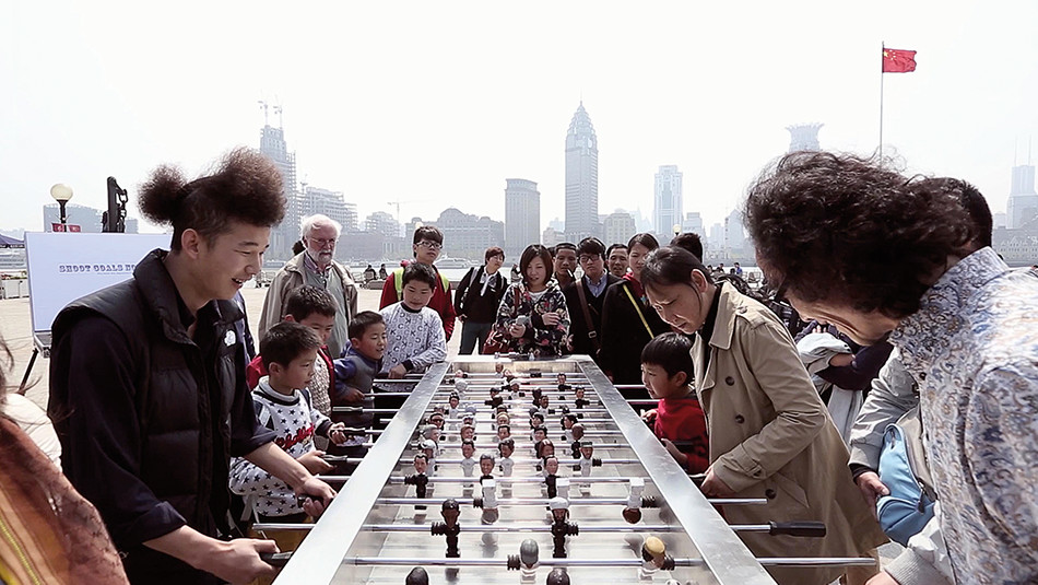 People playing on a foosball table