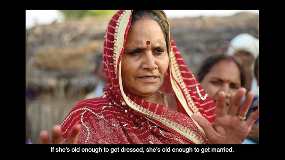 Screenshot showing a woman in a red sari