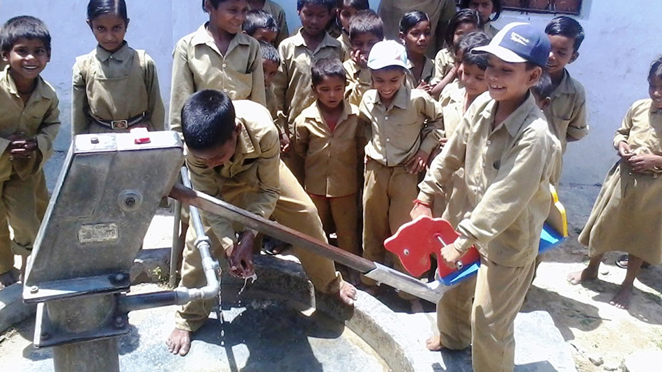 Children around a water pump